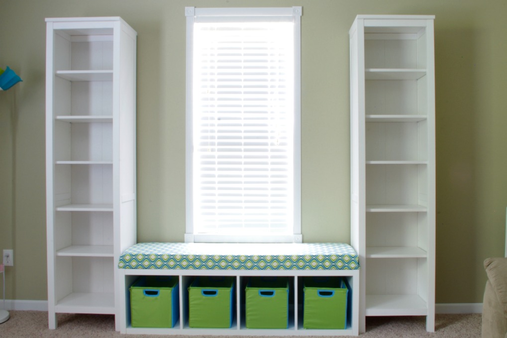 We created a fun bench seat in our playroom using an IKEA Kallax shelf unit. It is the perfect place for kids to sit and read a book! | #organization #organizing #storage #storagebins #organized #kallax #playroom