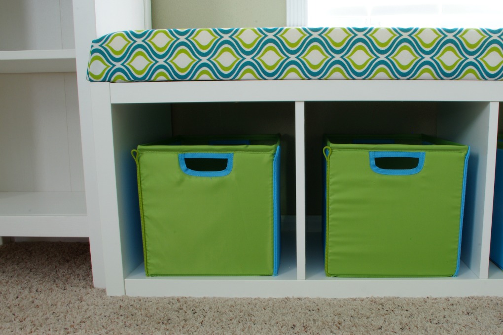 We created a fun bench seat in our playroom using an IKEA Kallax shelf unit. It is the perfect place for kids to sit and read a book! | #organization #organizing #storage #storagebins #organized #kallax #playroom