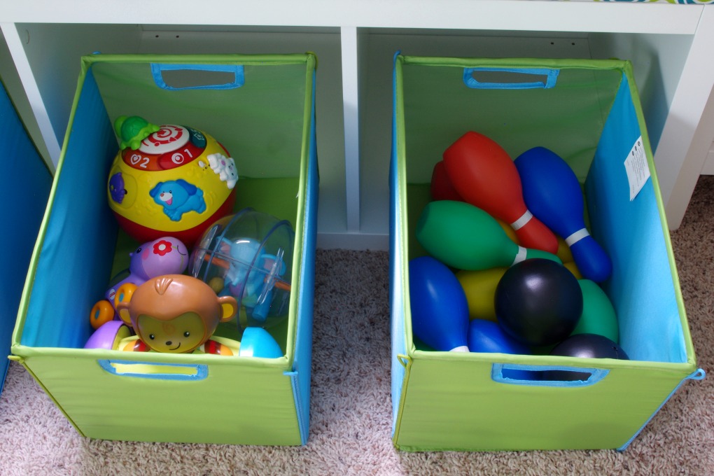 We made the bench seat in our playroom more functional. It is organized in a way that makes the most of the space we have! | #organization #organizing #storage #storagebins #organized #kallax #playroom