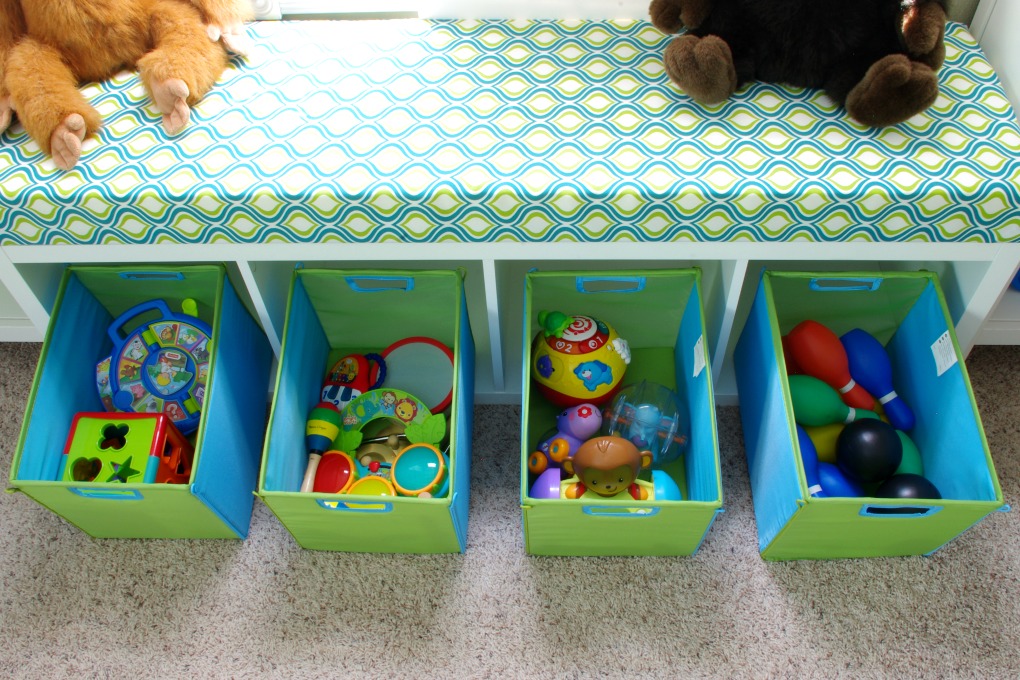 We made the bench seat in our playroom more functional. It is organized in a way that makes the most of the space we have! | #organization #organizing #storage #storagebins #organized #kallax #playroom